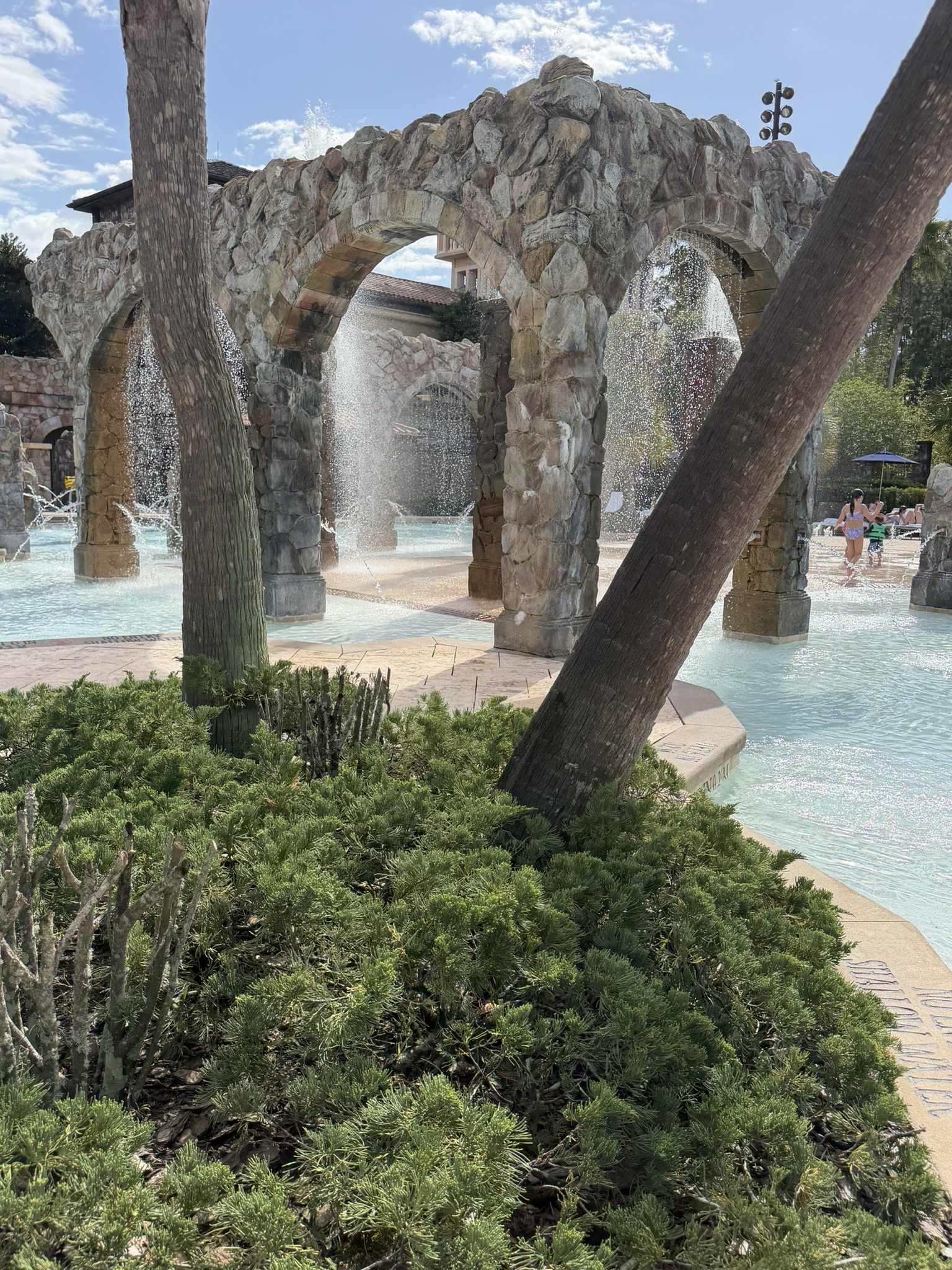 Splash zone stone archways with tropical landscaping